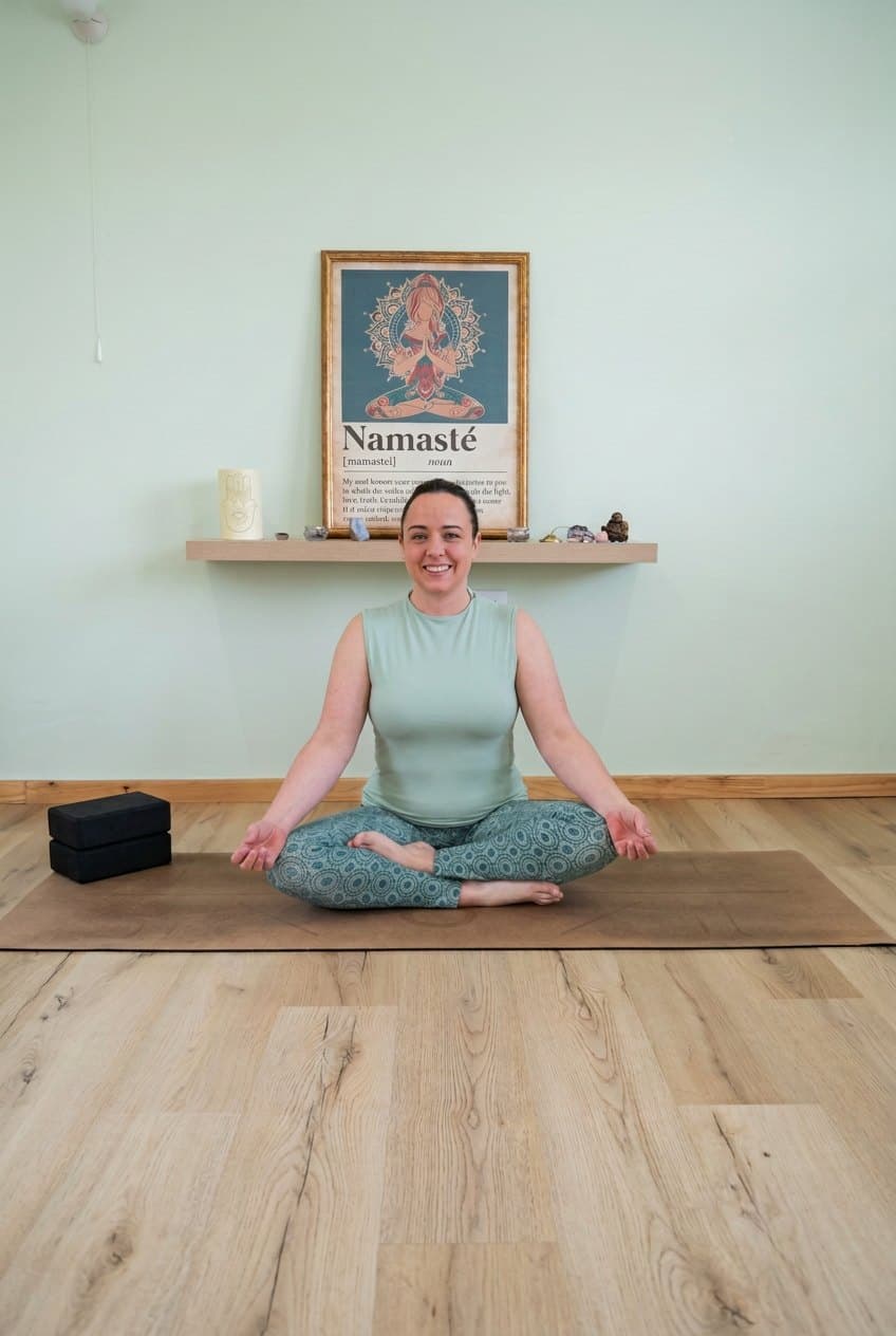 Kerry Nielsen, yoga teacher and therapist, seated in meditation in the Serendipity Wellness studio in Edgemead